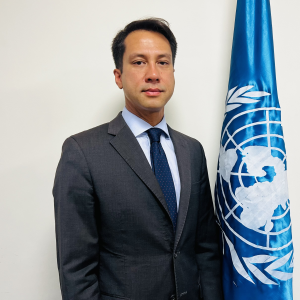 Photo of man standing with UN flag